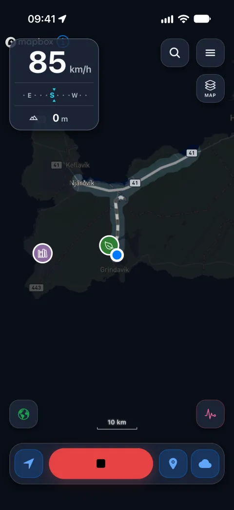 The night map while recording a new drive at 85 km/h: a fresh trail clearing the fog down to Grindavík, an older track glowing beside it, and saved places nearby